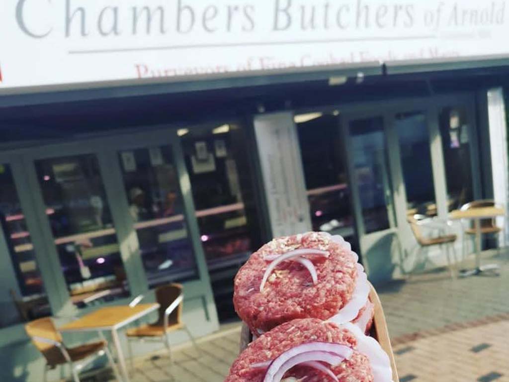 A whole fillet of beef with cut fillet steaks on a wooden board on the Chambers counter, taken just inside the shop